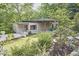 Contemporary single story home showcasing sleek lines, well-manicured lawn, and natural landscaping at 220 Glenhill Ln, Chapel Hill, NC 27514
