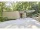 Modern house with flat roof, concrete driveway, natural landscaping, and covered parking at 220 Glenhill Ln, Chapel Hill, NC 27514