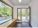 Open foyer with large windows, built-in seating, and a modern front door showcasing a bright entryway at 220 Glenhill Ln, Chapel Hill, NC 27514