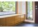 Foyer featuring a built-in bench under a large window, offering a view to the outdoors and ample storage space at 220 Glenhill Ln, Chapel Hill, NC 27514