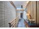 Stylish hallway with sleek black tile, wood paneling, and an upper transom window providing natural light at 220 Glenhill Ln, Chapel Hill, NC 27514