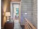 View of a tiled hallway featuring wood paneled walls, neutral decor, and a view to the adjacent room at 220 Glenhill Ln, Chapel Hill, NC 27514