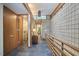 Hallway featuring stone tile wall, clerestory window, slate flooring and wood railing at 220 Glenhill Ln, Chapel Hill, NC 27514