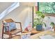 Cozy view of a home office space with decorative plants, a stylish chair, and natural light at 220 Glenhill Ln, Chapel Hill, NC 27514