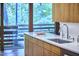Bright kitchen featuring wooden cabinets, quartz countertops, and stainless appliances, with windows to the outside at 220 Glenhill Ln, Chapel Hill, NC 27514