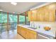 Bright kitchen featuring modern cabinetry, stainless steel appliances, and a large window offering wooded views at 220 Glenhill Ln, Chapel Hill, NC 27514
