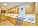 Modern kitchen featuring stainless steel appliances, white countertops, and natural wood cabinets at 220 Glenhill Ln, Chapel Hill, NC 27514