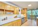 Chef's kitchen with premium appliances, light wood cabinets, and an amazing outdoor view at 220 Glenhill Ln, Chapel Hill, NC 27514