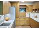Updated kitchen with stainless steel appliances, natural wood cabinets, and modern fixtures at 220 Glenhill Ln, Chapel Hill, NC 27514