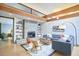 Bright living room with a fireplace, wooden beams, modern furniture, and open access to the bedroom at 220 Glenhill Ln, Chapel Hill, NC 27514
