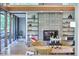 Comfortable living room featuring a fireplace, tile wall, open shelving, and wooden beams at 220 Glenhill Ln, Chapel Hill, NC 27514