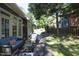 Inviting backyard with a wooden deck, patio furniture, privacy fence, and lush landscaping at 221 Ironwoods Dr, Chapel Hill, NC 27516