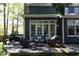 Backyard view features outdoor seating, patio furniture, and an open grill at 221 Ironwoods Dr, Chapel Hill, NC 27516