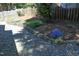 Charming backyard with stone pathway, rock wall, wood fence, and mature landscaping at 221 Ironwoods Dr, Chapel Hill, NC 27516