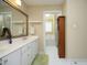 Bright bathroom features double vanity with white cabinets, large mirror, and a separate tub and shower area at 221 Ironwoods Dr, Chapel Hill, NC 27516