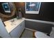 Powder room featuring black walls, gold-framed mirror, and pedestal sink at 221 Ironwoods Dr, Chapel Hill, NC 27516