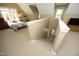 Spacious bedroom featuring a sloped ceiling, neutral carpet, and a staircase to a lower level at 221 Ironwoods Dr, Chapel Hill, NC 27516