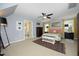 Primary bedroom featuring a ceiling fan, carpet flooring, and ensuite bathroom at 221 Ironwoods Dr, Chapel Hill, NC 27516