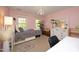 Charming bedroom with pink walls, light fixture, and a large dresser with mirror at 221 Ironwoods Dr, Chapel Hill, NC 27516