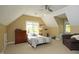Bedroom with sloping ceilings and a bed, with plenty of natural light at 221 Ironwoods Dr, Chapel Hill, NC 27516