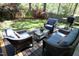 Outdoor deck with wicker furniture perfect for relaxing and entertaining with lush green trees at 221 Ironwoods Dr, Chapel Hill, NC 27516