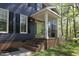 Inviting front entrance with a bright green door, brick steps, and iron railings at 221 Ironwoods Dr, Chapel Hill, NC 27516