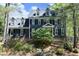 Charming two-story home with black shutters, dormer windows, and a beautifully landscaped front yard at 221 Ironwoods Dr, Chapel Hill, NC 27516