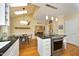 Open concept kitchen with stainless steel range and view of the breakfast nook and living room at 221 Ironwoods Dr, Chapel Hill, NC 27516