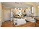 Bright kitchen featuring white cabinets, dark countertops, stainless steel appliances, and hardwood floors at 221 Ironwoods Dr, Chapel Hill, NC 27516