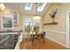 Bright kitchen with breakfast nook featuring skylight, hardwood floors, and backyard views at 221 Ironwoods Dr, Chapel Hill, NC 27516