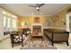 Cozy living room with fireplace, neutral decor, and french doors leading to the exterior at 221 Ironwoods Dr, Chapel Hill, NC 27516