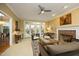 Bright living room featuring a fireplace, ceiling fan, and plenty of natural light at 221 Ironwoods Dr, Chapel Hill, NC 27516