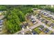 Aerial view of a community, mature trees, and a serene pond in a desirable location at 2215 Montebell View Dr, Fuquay Varina, NC 27526