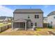 Back exterior of home, showing a covered patio and grilling area in a fenced yard at 2215 Montebell View Dr, Fuquay Varina, NC 27526