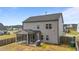 Rear exterior of home featuring a covered patio and grilling area in a spacious, fenced yard at 2215 Montebell View Dr, Fuquay Varina, NC 27526