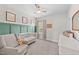Charming Bedroom featuring a crib, comfortable armchair, and soft, neutral tones at 2215 Montebell View Dr, Fuquay Varina, NC 27526