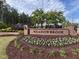 Well-manicured entrance to the Meadowbrook community with lush landscaping at 2215 Montebell View Dr, Fuquay Varina, NC 27526
