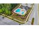 Aerial view showcases the pool area, playground, and surrounding lush landscaping at 2215 Montebell View Dr, Fuquay Varina, NC 27526