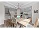 Open dining room view featuring hardwood floors and modern lighting at 2215 Montebell View Dr, Fuquay Varina, NC 27526