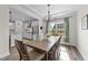 Dining area features hardwood floors, elegant chandelier, and view into kitchen area at 2215 Montebell View Dr, Fuquay Varina, NC 27526