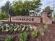 Community entrance sign surrounded by colorful flowers and greenery at 2215 Montebell View Dr, Fuquay Varina, NC 27526