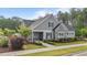 Charming home featuring stone accents, professionally landscaped yard, and inviting entryway at 2215 Montebell View Dr, Fuquay Varina, NC 27526
