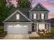 Charming two-story home featuring a well-manicured lawn, inviting porch seating, and a two-car garage at 2215 Montebell View Dr, Fuquay Varina, NC 27526