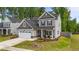 Attractive two-story home boasts a manicured lawn, inviting front porch and a two-car garage at 2215 Montebell View Dr, Fuquay Varina, NC 27526