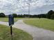 Fuquay-Varina Greenway Rules and Regulations sign next to a walking trail and soccer field at 2215 Montebell View Dr, Fuquay Varina, NC 27526