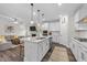 Open-concept kitchen with large island, granite counters, and access to the living room at 2215 Montebell View Dr, Fuquay Varina, NC 27526
