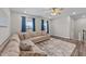 Bright living room with a comfortable sectional sofa, large windows, and elegant curtains at 2215 Montebell View Dr, Fuquay Varina, NC 27526