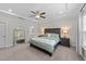 Elegantly appointed primary bedroom features a tray ceiling, refined decor, and soft, natural light at 2215 Montebell View Dr, Fuquay Varina, NC 27526