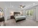 Spacious main bedroom features a tray ceiling, plush bedding, and bright, natural light at 2215 Montebell View Dr, Fuquay Varina, NC 27526