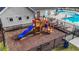 Community playground with a slide and climbing structure for to enjoy at 2215 Montebell View Dr, Fuquay Varina, NC 27526